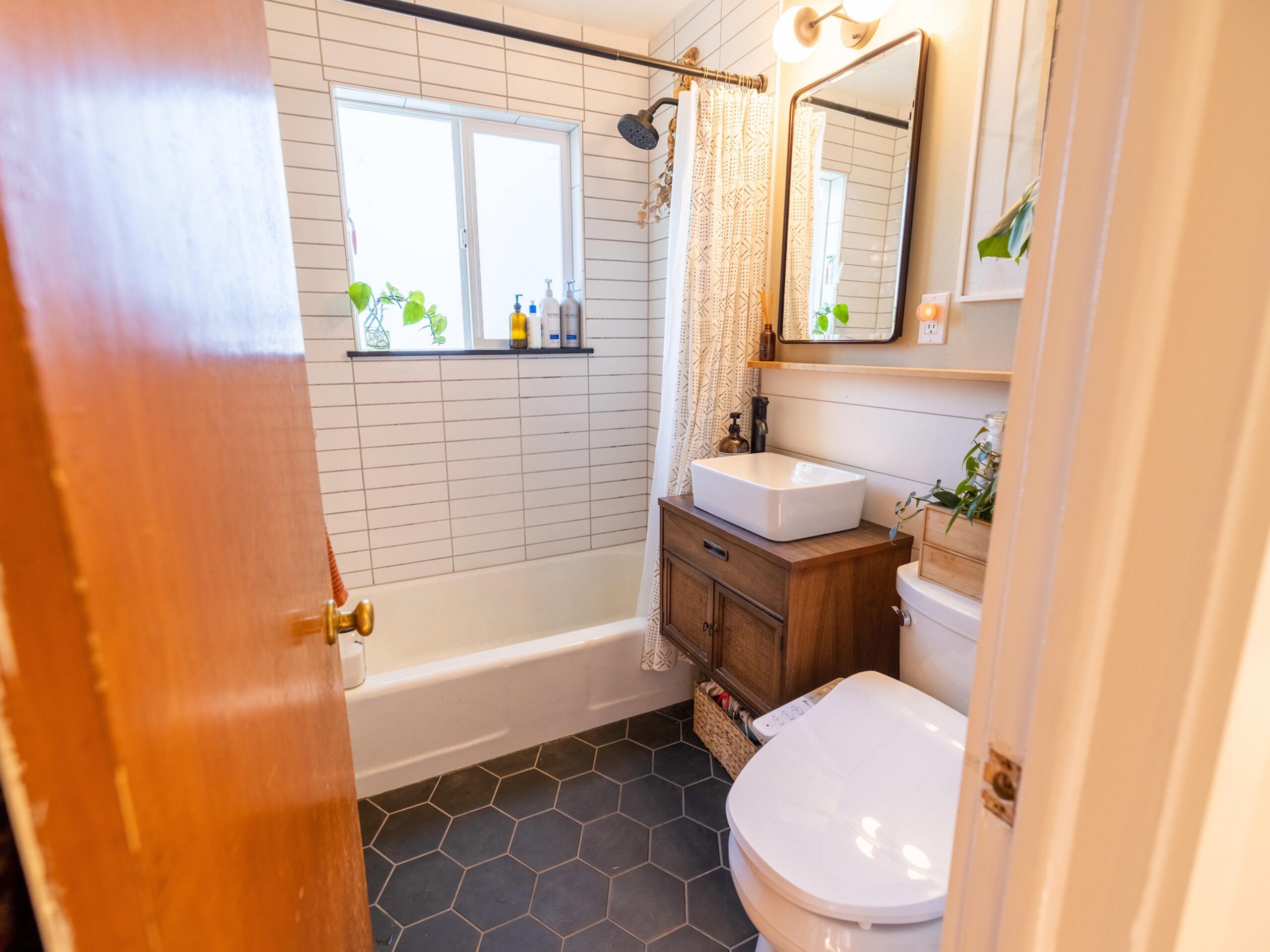 Full bathroom gut and remodel with custom tile shower surround.