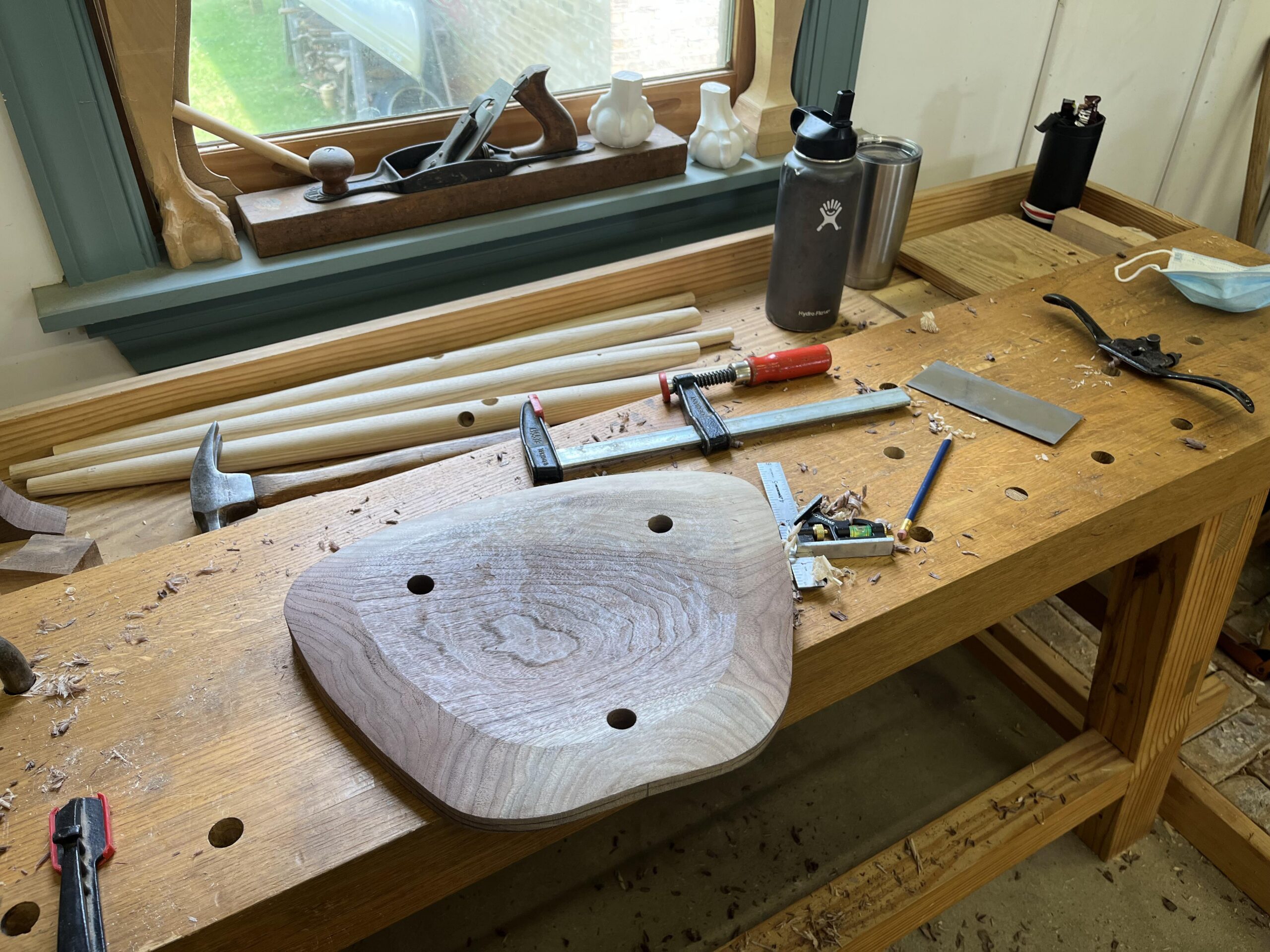 Hand-shaped Walnut stool seat base.