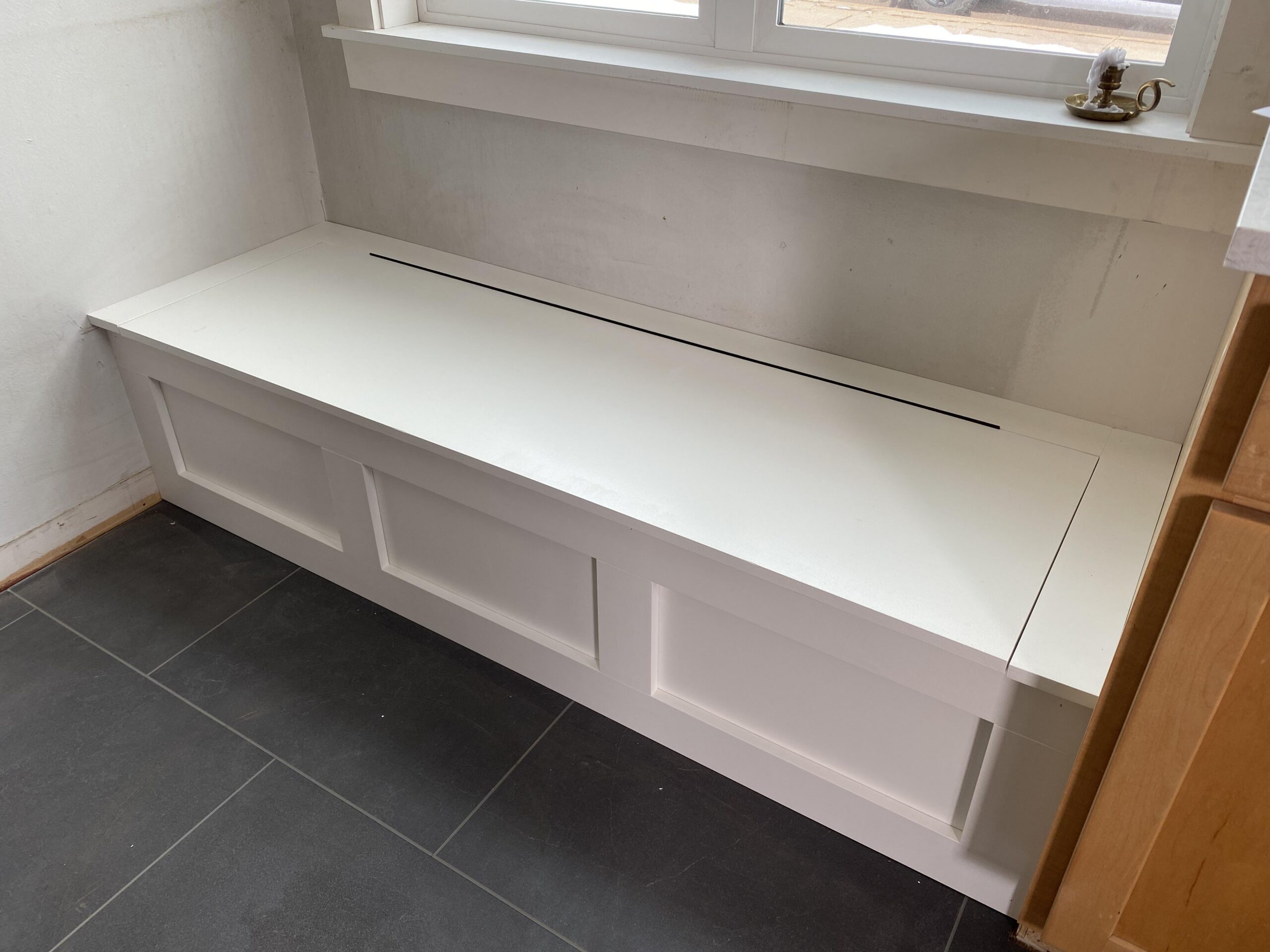 Custom built-in breakfast nook with hinged top for storage.