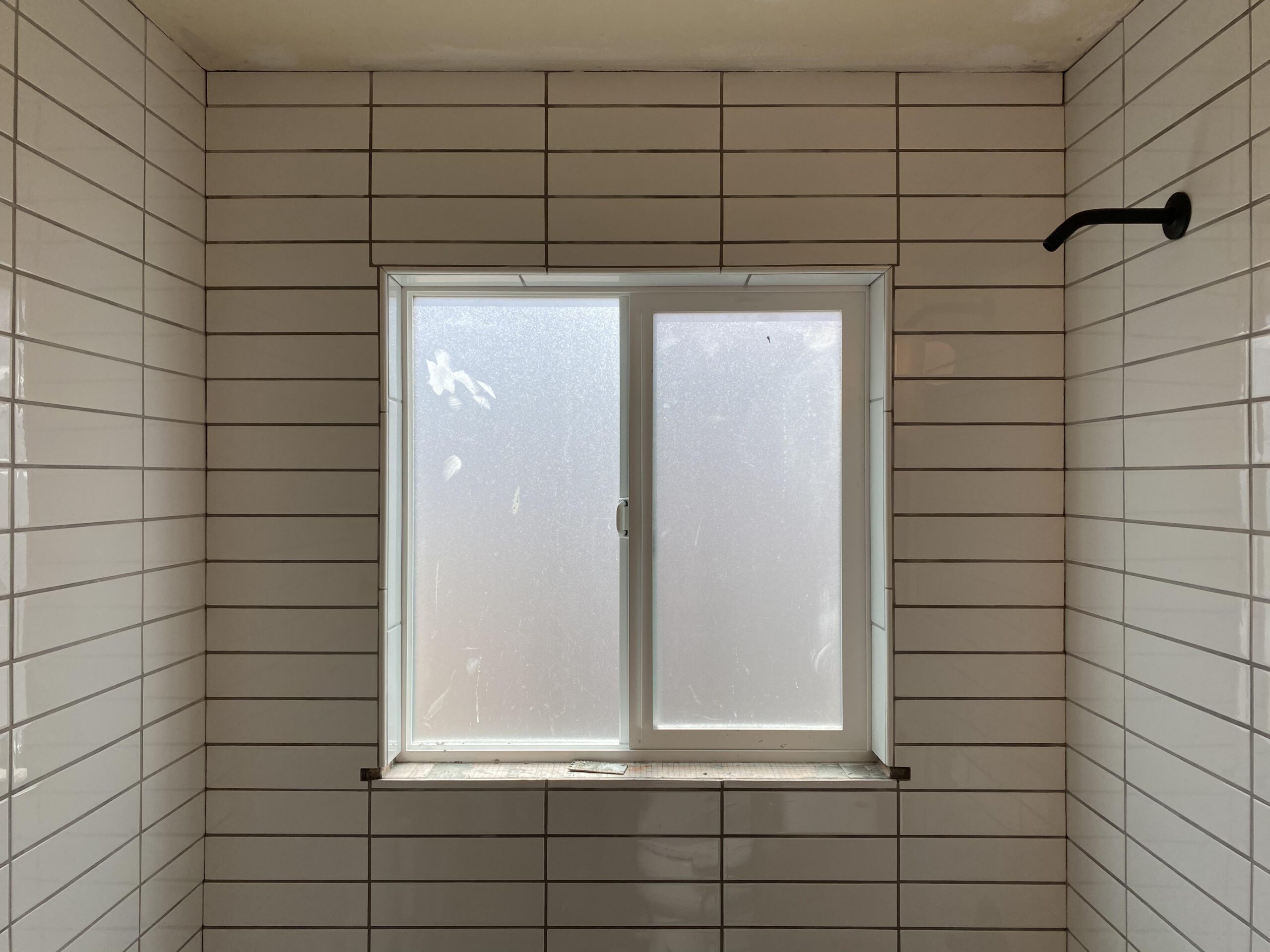 New shower surround with Schleuter Kerdi Board, custom tile, and new window.