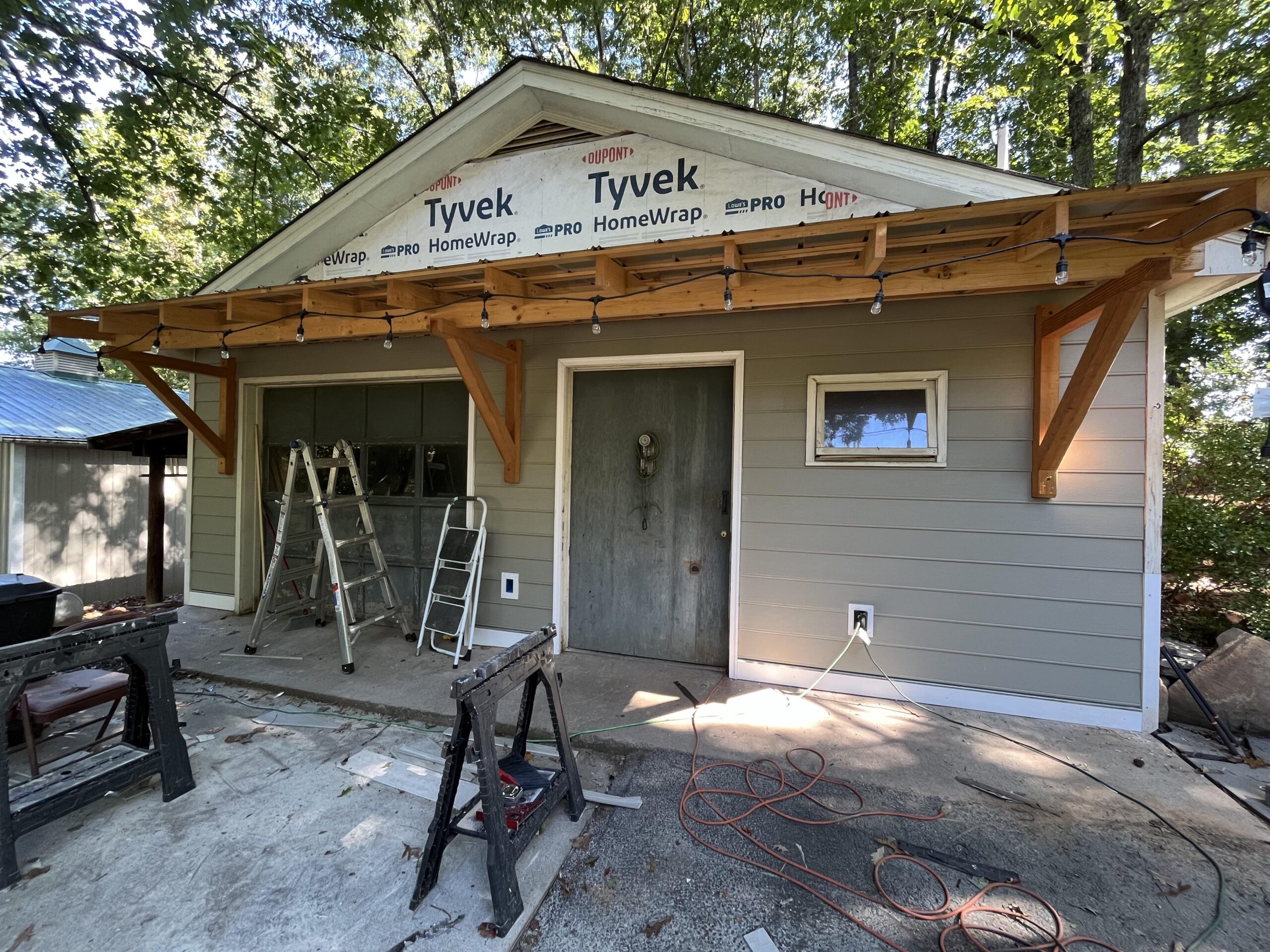 Completed awning with new Hardi Plank siding being installed.
